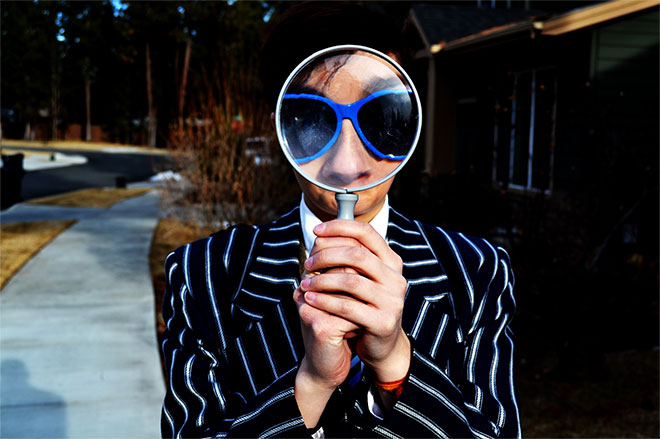 man with magnifying glass and funny jacket