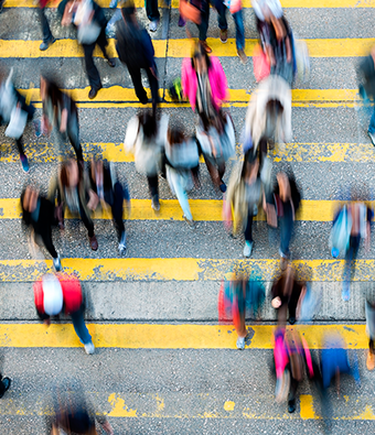 artistic image of people walking across a city street